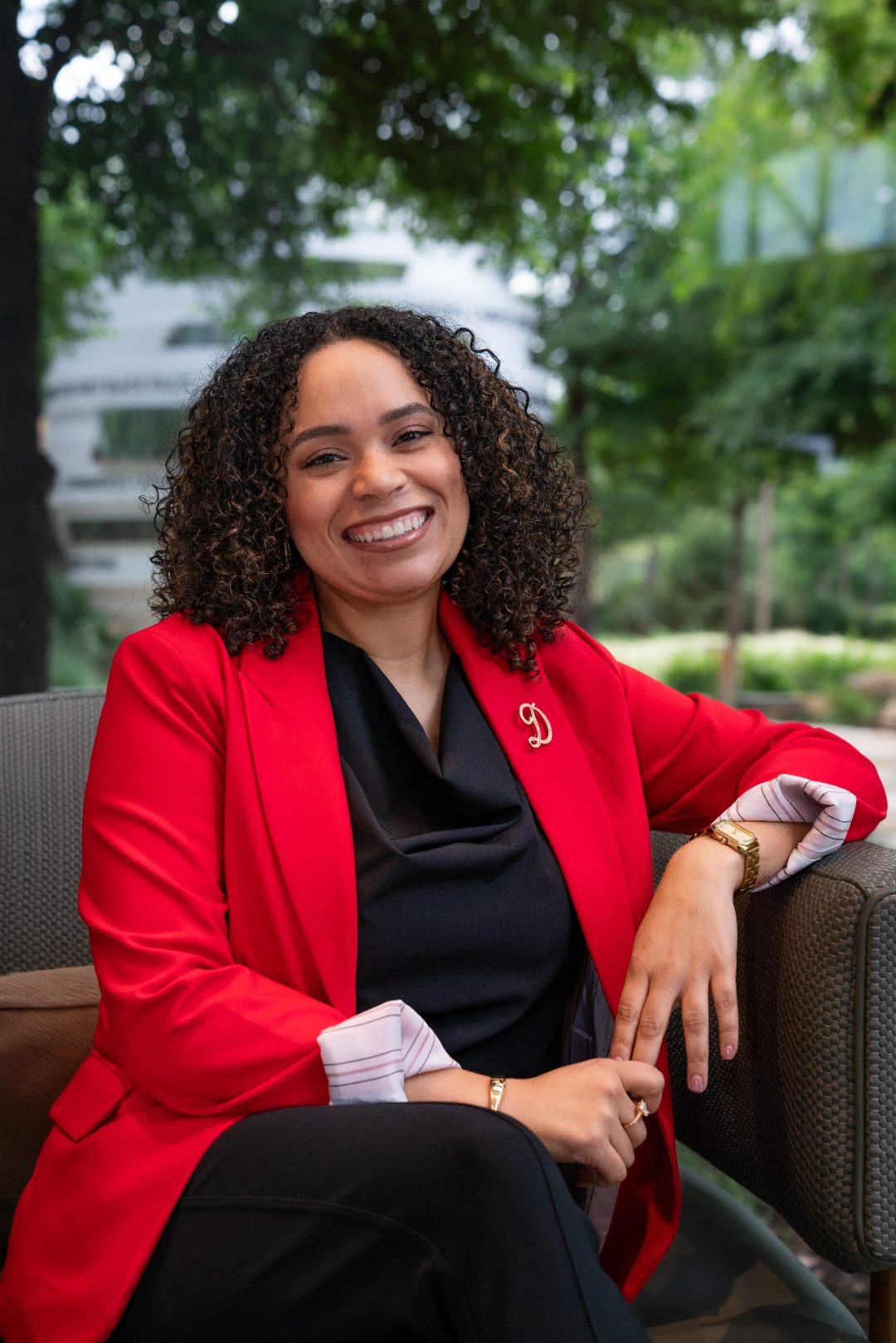 Professional headshot - woman in red blazer outdoor setting