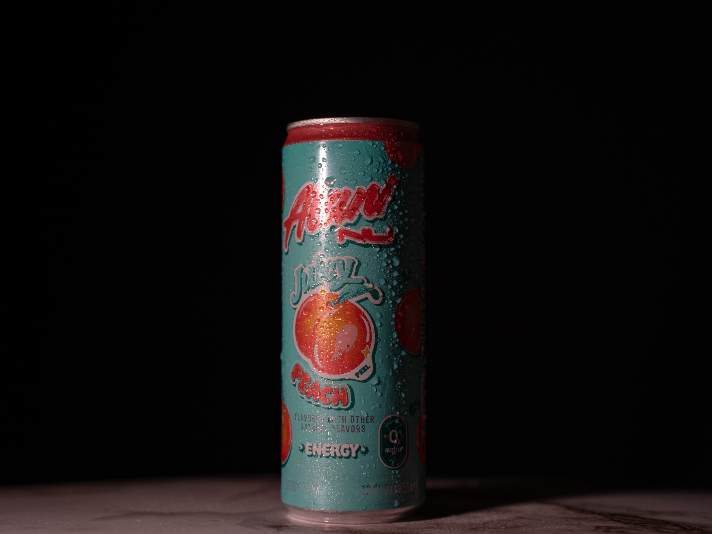 Alani Nu Juicy Peach energy drink product photography - dark studio with condensation